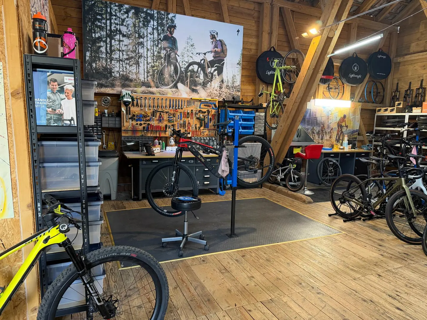 Werkstattbereich mit einem E-Mountainbike im Ständer und Velos im Verkauf